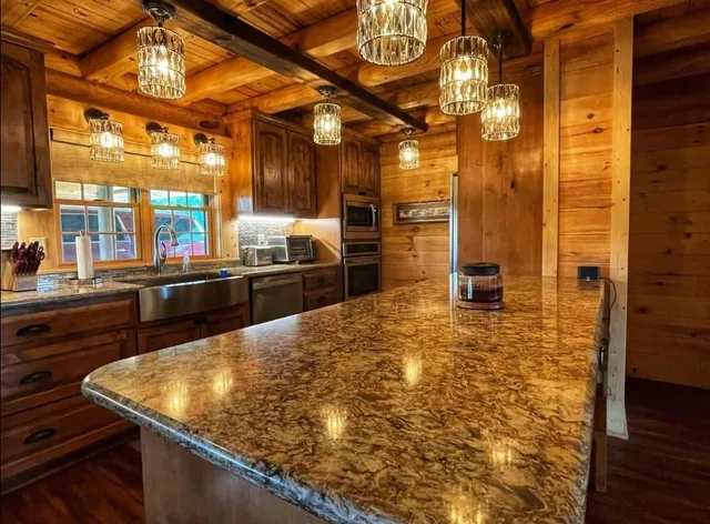 a view of a kitchen with a sink and wooden floor