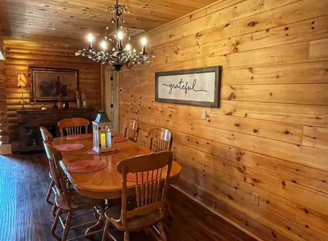 a view of a dining room with furniture and chandelier