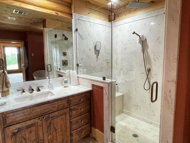 a spacious bathroom with a shower sink and mirror