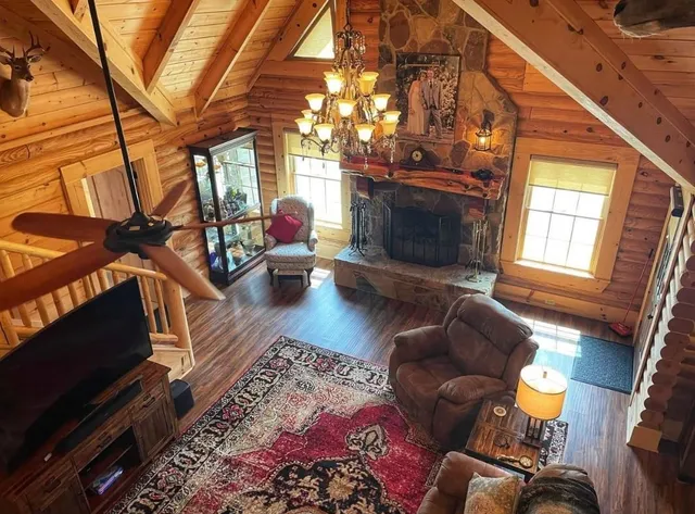 a living room with furniture a fireplace and a flat screen tv