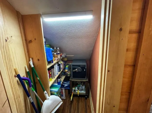 a view of a hallway with wooden floor and stairs