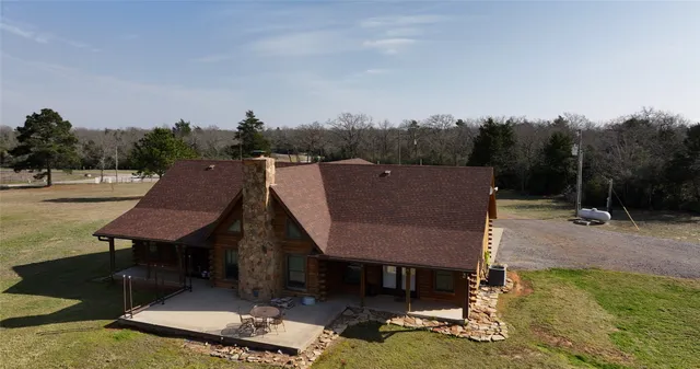 a aerial view of a house with swimming pool and a yard