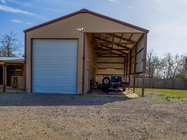 a view of a house with backyard and a tree
