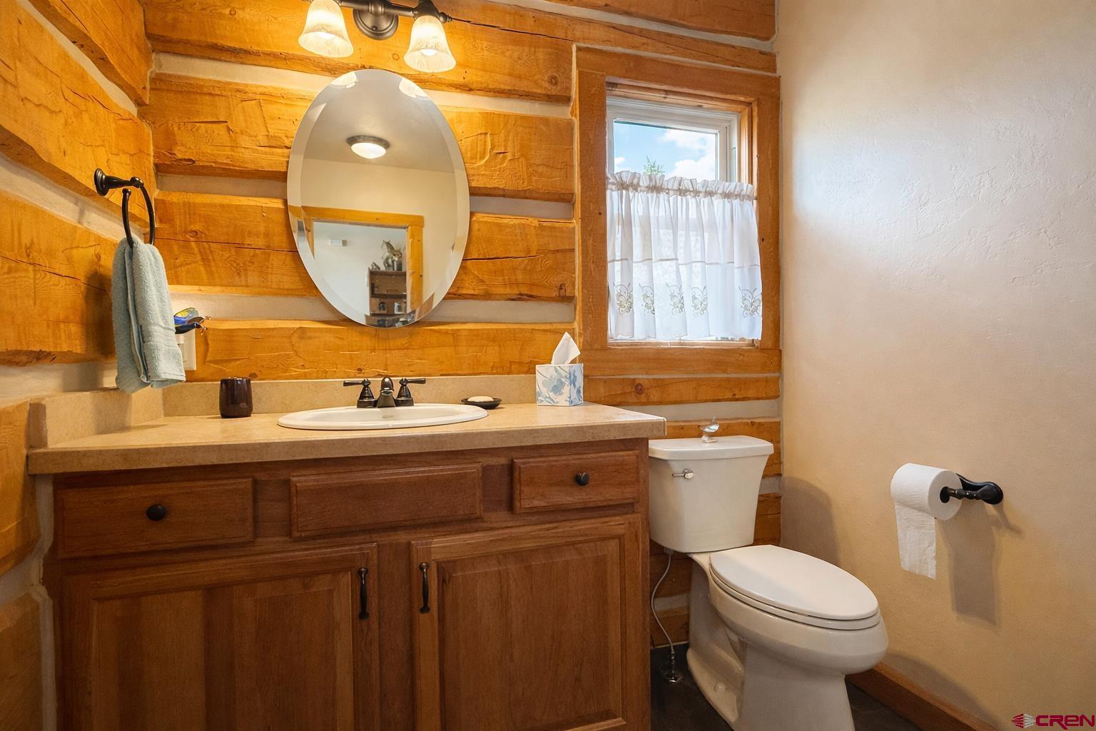 6493 Townsend Road Delta, CO 81416 - Photo 11 of 38 a bathroom with a granite countertop toilet sink and mirror