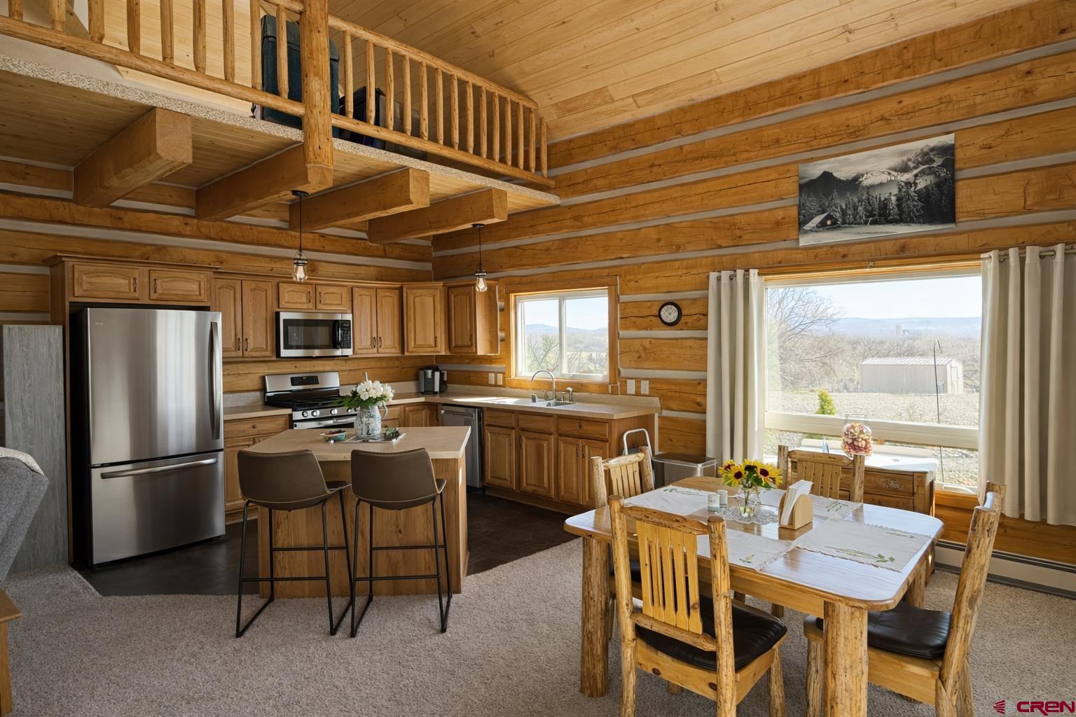 6493 Townsend Road Delta, CO 81416 - Photo 19 of 38 a kitchen with a table chairs refrigerator and cabinets