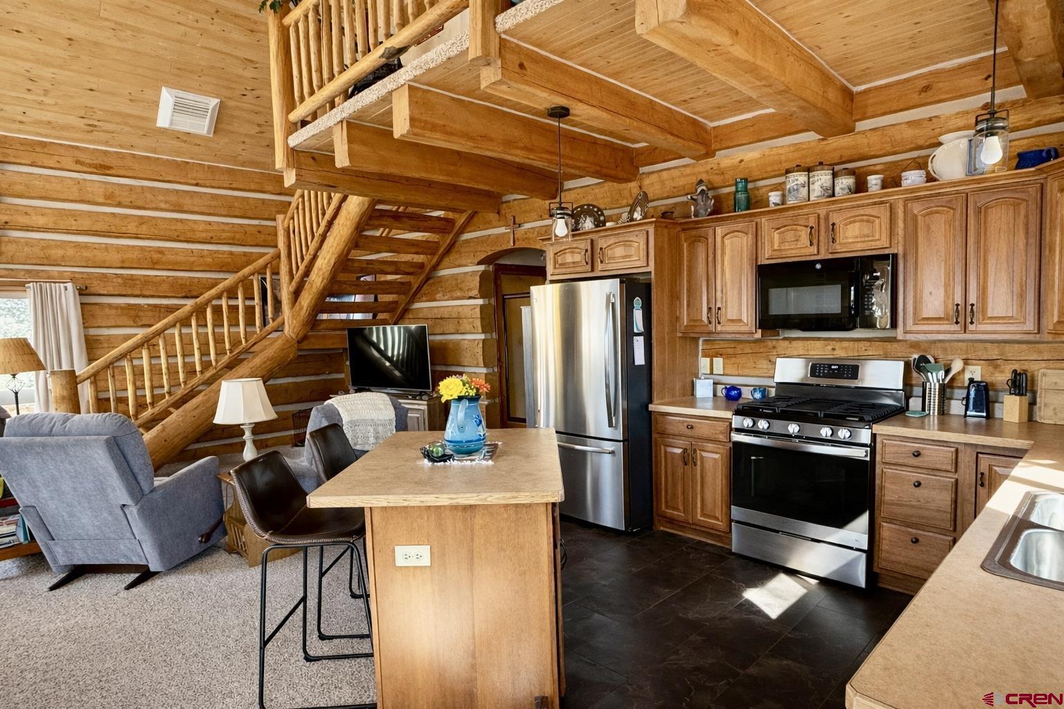 6493 Townsend Road Delta, CO 81416 - Photo 20 of 38 a kitchen with stainless steel appliances and wooden floor