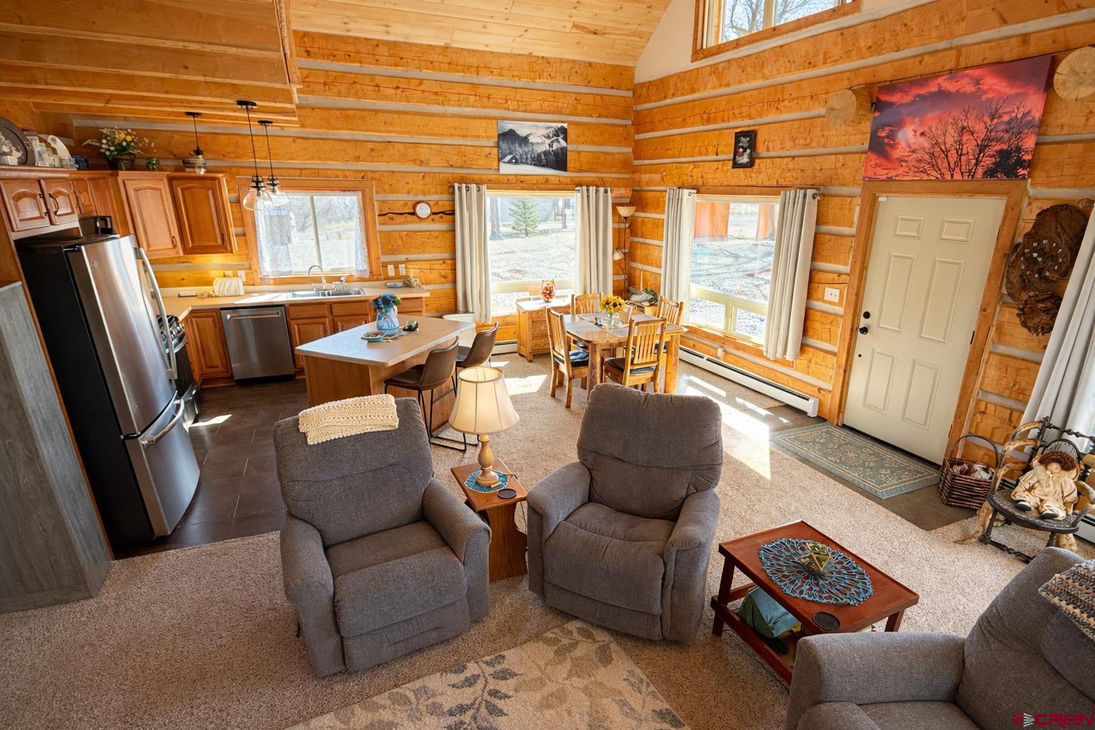 6493 Townsend Road Delta, CO 81416 - Photo 2 of 38 a living room with furniture a large window and a flat screen tv