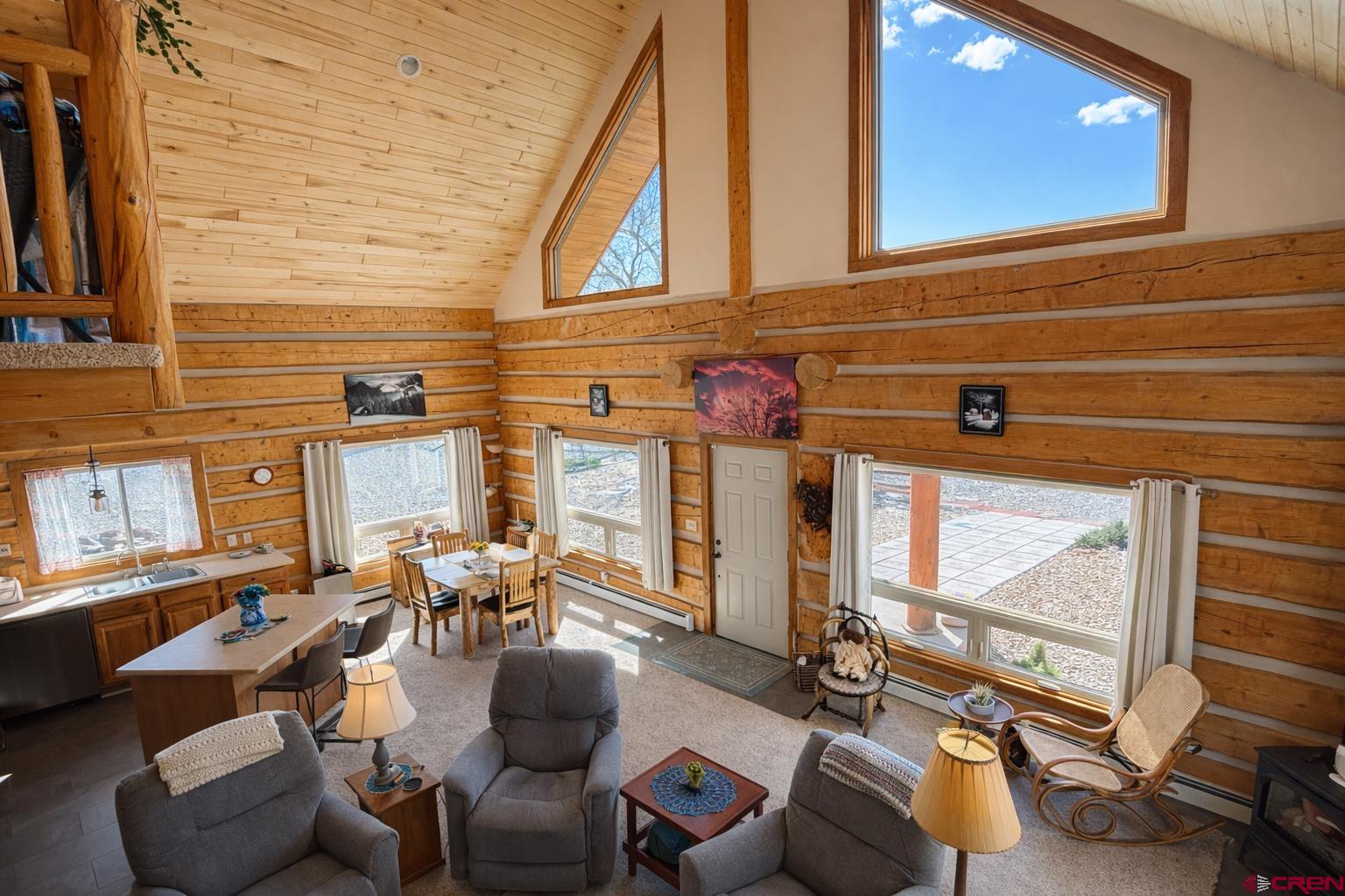 6493 Townsend Road Delta, CO 81416 - Photo 3 of 38 a living room with furniture a floor to ceiling window and a flat screen tv