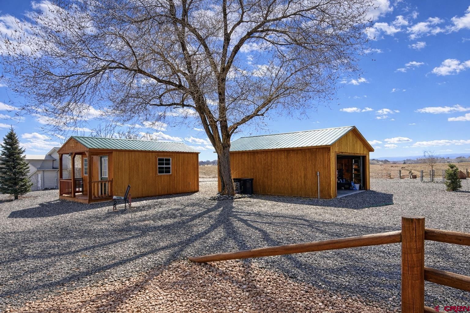 6493 Townsend Road Delta, CO 81416 - Photo 31 of 38 a view of a house with large trees next to a yard and large tree