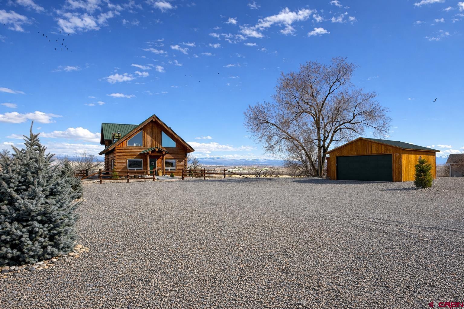 6493 Townsend Road Delta, CO 81416 - Photo 38 of 38 a front view of house with yard and trees in the background