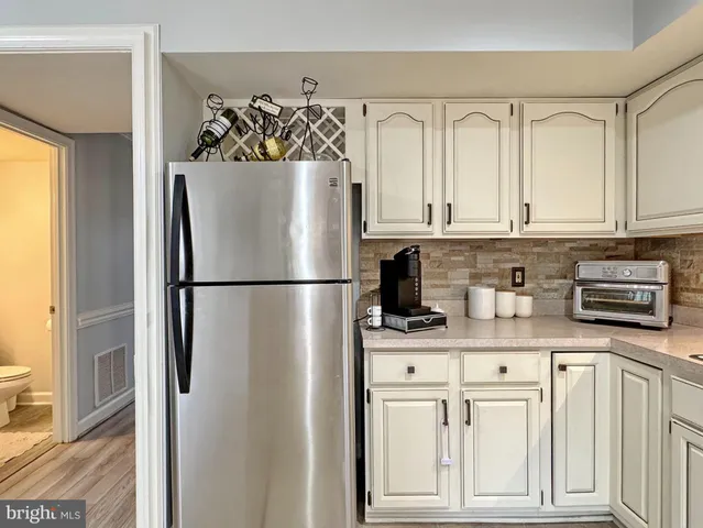 a kitchen with a refrigerator and a stove