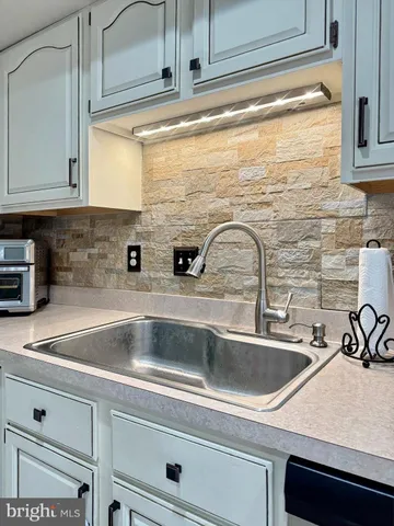 a kitchen with a stove a sink and a refrigerator