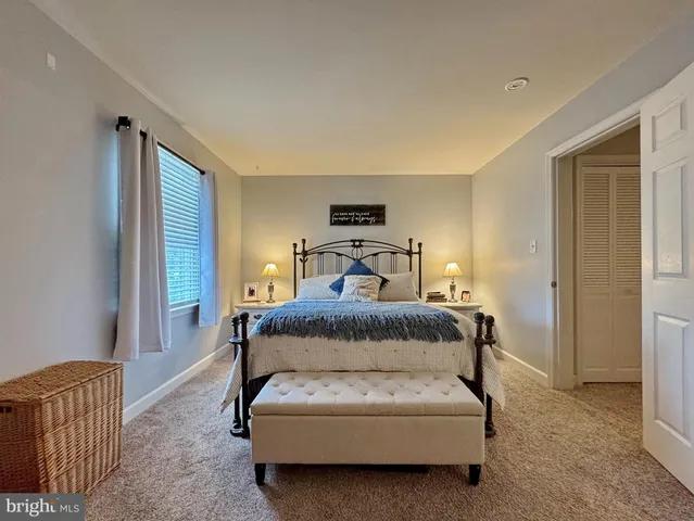 a view of staircase with lots of frames on wall and a window