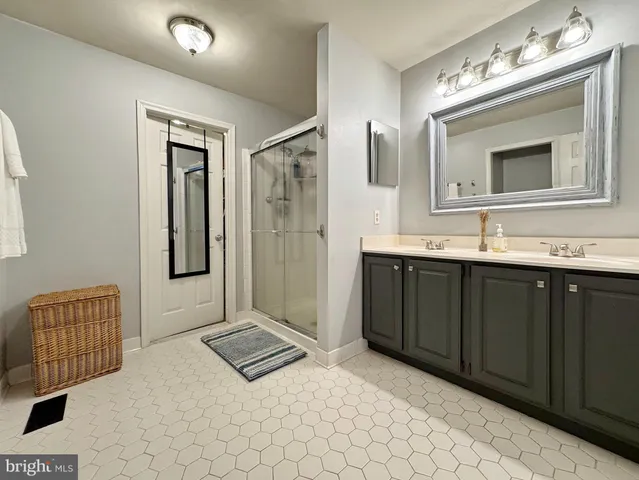a living room with furniture a rug and white walls