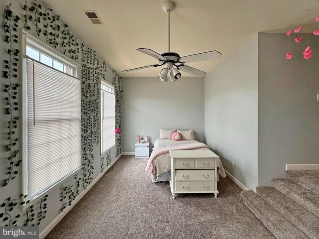 a bedroom with furniture and window