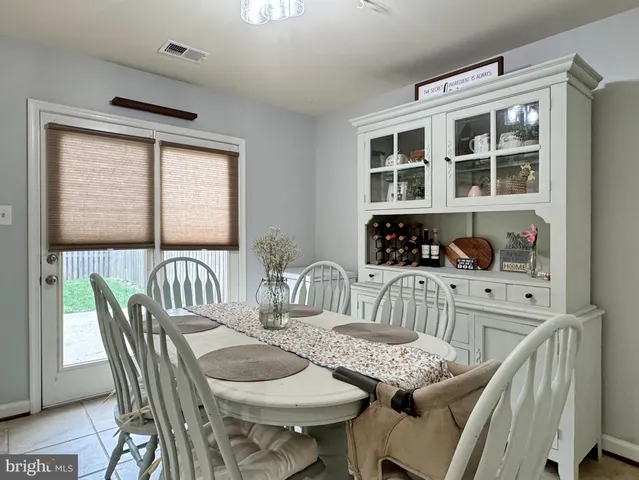 a living room with furniture a rug and a window