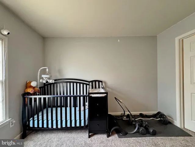 a front view of a house with a tree