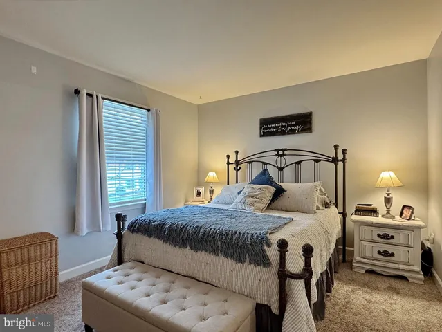 a living room with furniture a flat screen tv and a large window