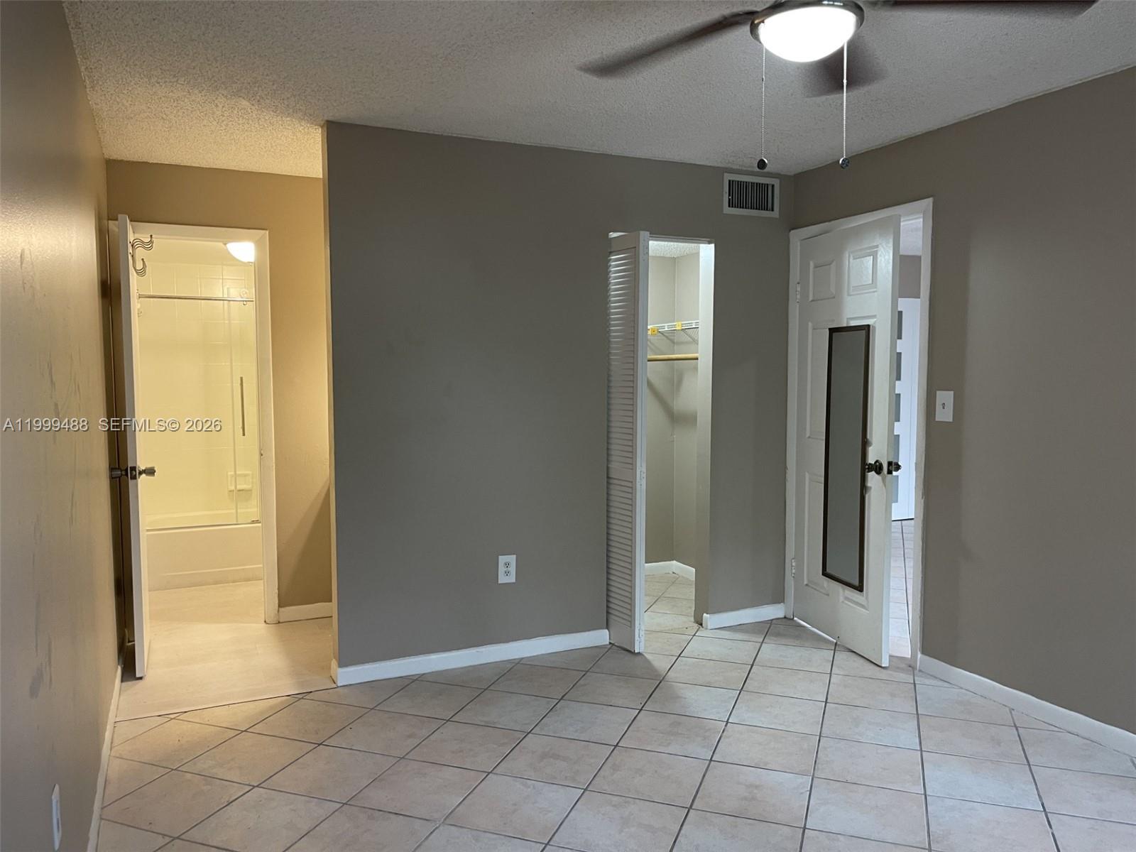 1250 Lincoln Road, Unit 306 Miami Beach, FL 33139 - Photo 8 of 12 an empty room with closet and a chandelier fan