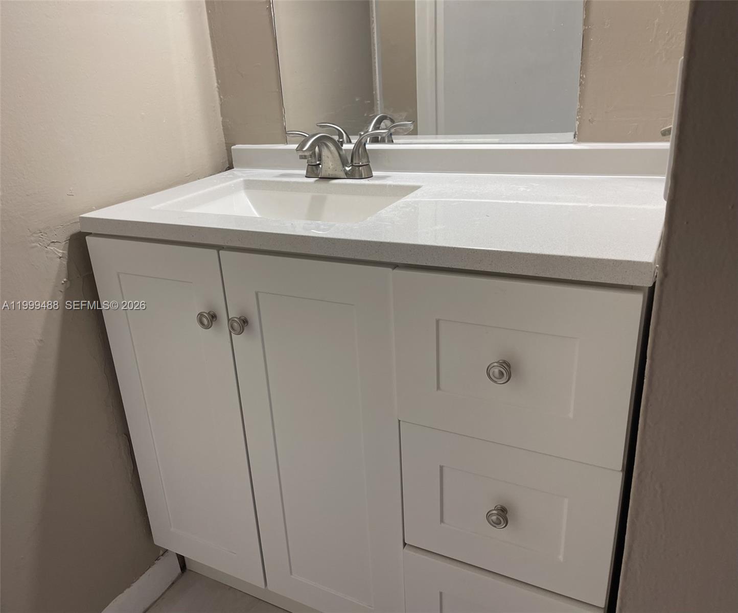 1250 Lincoln Road, Unit 306 Miami Beach, FL 33139 - Photo 10 of 12 a bathroom with a sink and mirror