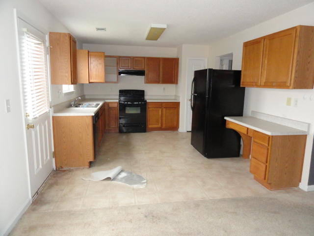339 Dahlquist Drive Crestview, FL 32539 - Photo 4 of 15 a kitchen with a refrigerator and a sink