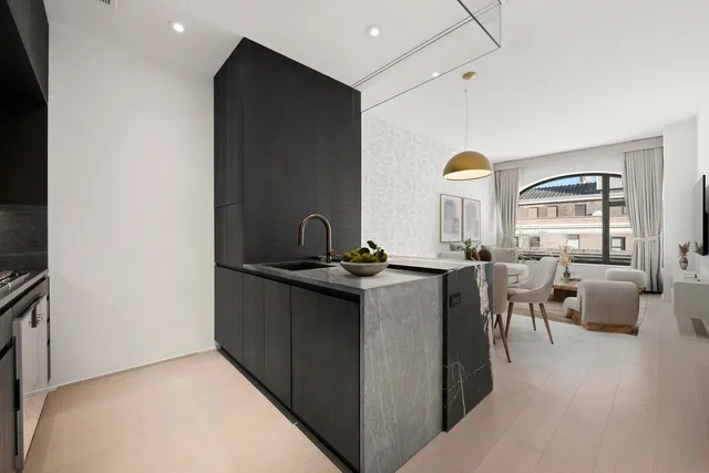 a living room with furniture and view of kitchen