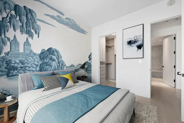 a bedroom with bed and wooden floor