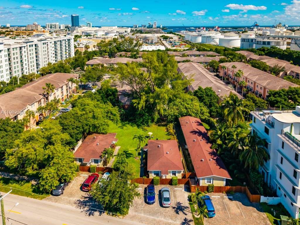 an aerial view of multiple houses with yard