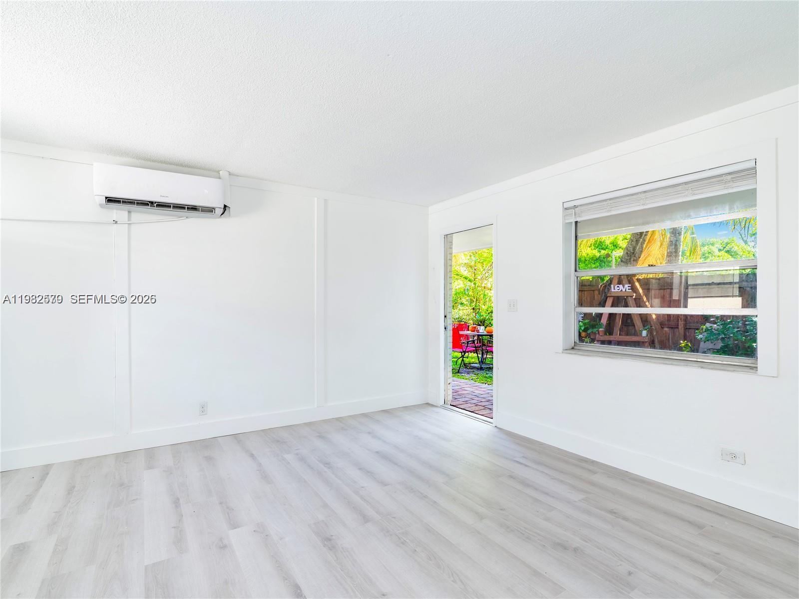 2020 Miami Road, Unit B Fort Lauderdale, FL 33316 - Photo 2 of 9 an empty room with window and wooden floor