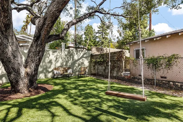 a view of a backyard with a tree