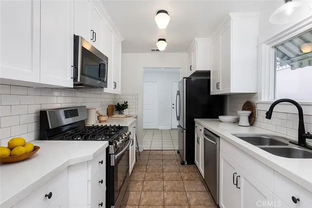 a kitchen with a sink stove and refrigerator