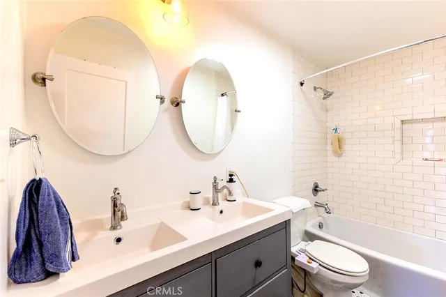 a bathroom with a toilet a sink and a mirror