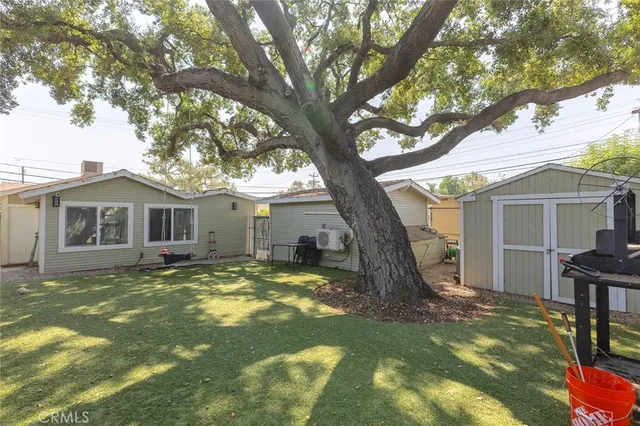 a view of a house with swimming pool and a yard