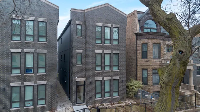 a front view of a residential apartment building with a yard