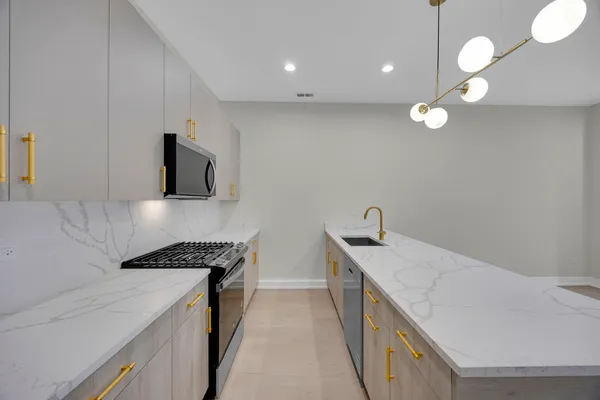 a kitchen that has a microwave and a sink