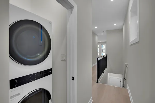 a view of a hallway with washer and dryer