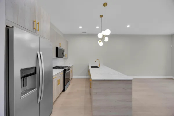 a kitchen with stainless steel appliances a refrigerator sink and stove