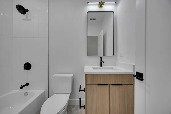 a bathroom with a sink toilet and shower