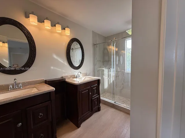 a bathroom with a double vanity sink and a mirror