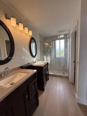 a bathroom with a double vanity sink and a mirror