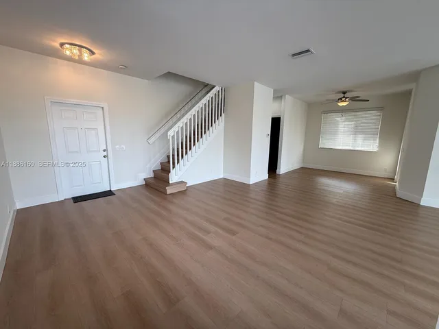a bathroom with a double vanity sink toilet and a mirror