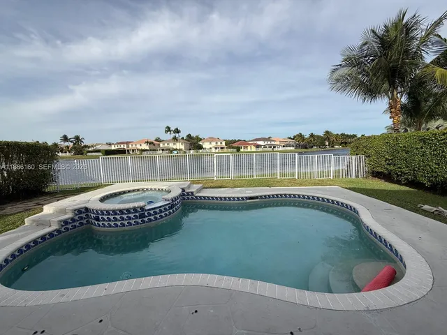 a view of a swimming pool with a yard