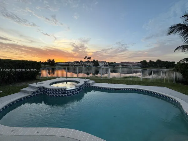 a view of a swimming pool with a yard