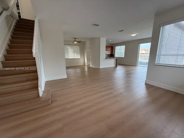 an entryway of a house with wooden floor