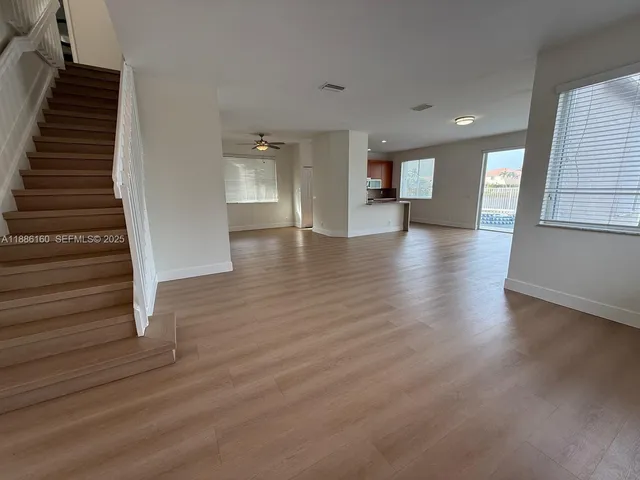 a kitchen with stainless steel appliances kitchen island granite countertop a stove a sink and a refrigerator