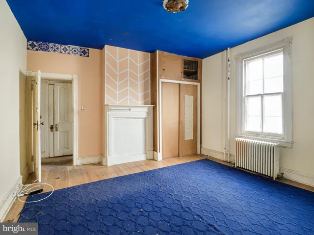 an entryway with wooden floor and cabinet