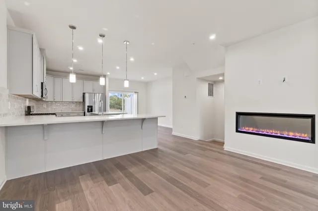 a view of a kitchen with wooden floor and a sink