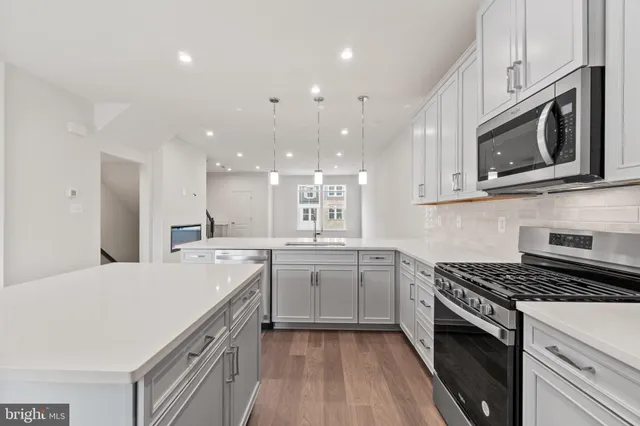 a kitchen with a sink stove and microwave