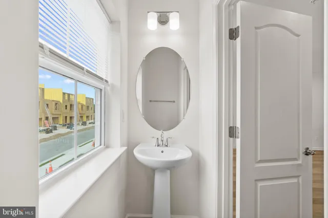 a bathroom with a sink a mirror and a shower