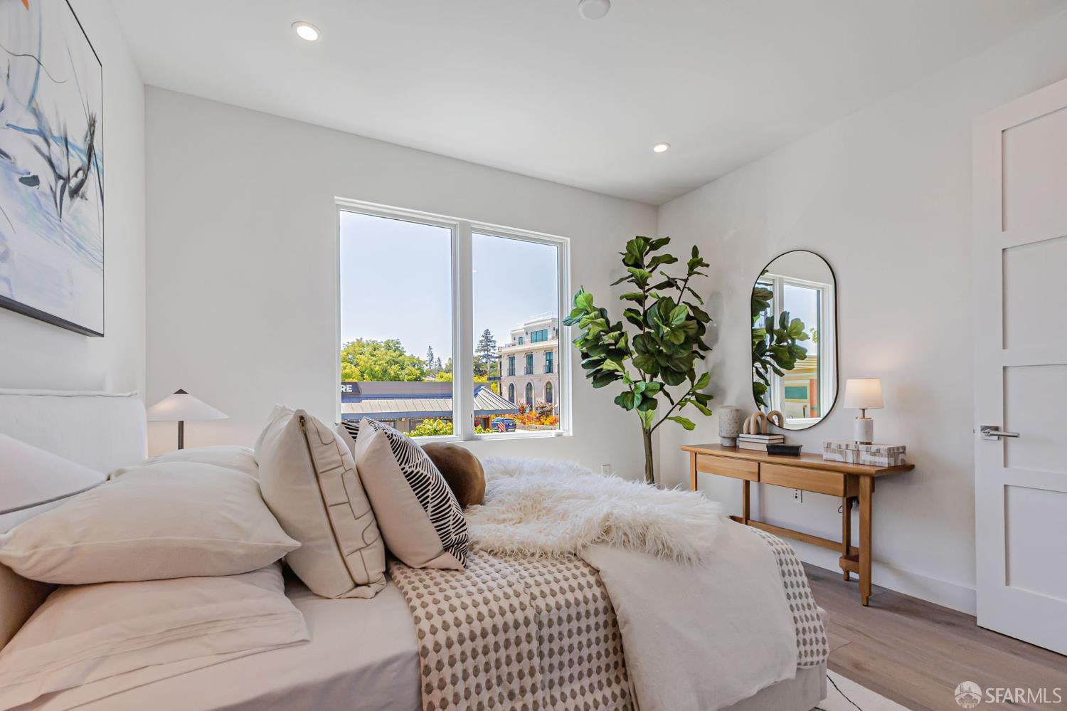 425 1st Street, Unit 21 Los Altos, CA 94022 - Photo 19 of 41 a bedroom with a bed table flowerpot and a window